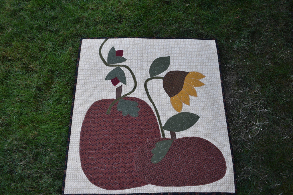 Quilt:  A Quilt measuring 30" high by 26.5" wide    Featuring Two Pumpkins, a Sunflower and other Flowers