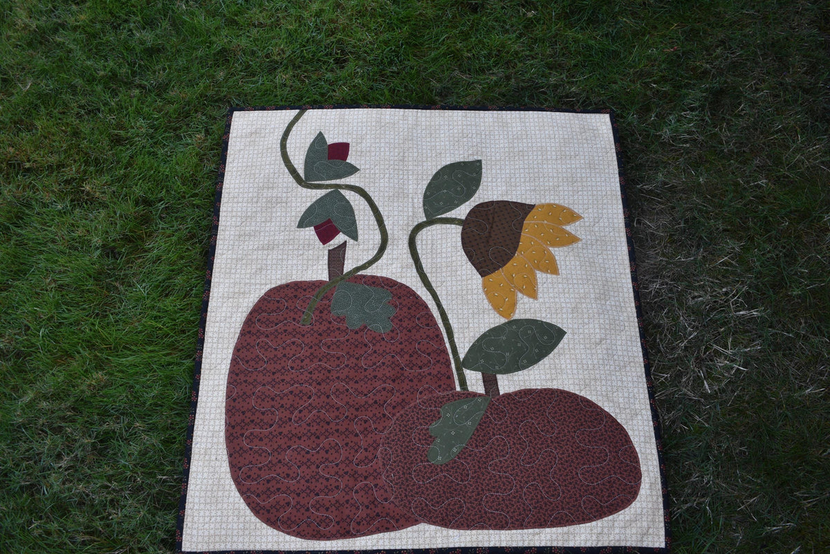Quilt:  A Quilt measuring 30" high by 26.5" wide    Featuring Two Pumpkins, a Sunflower and other Flowers