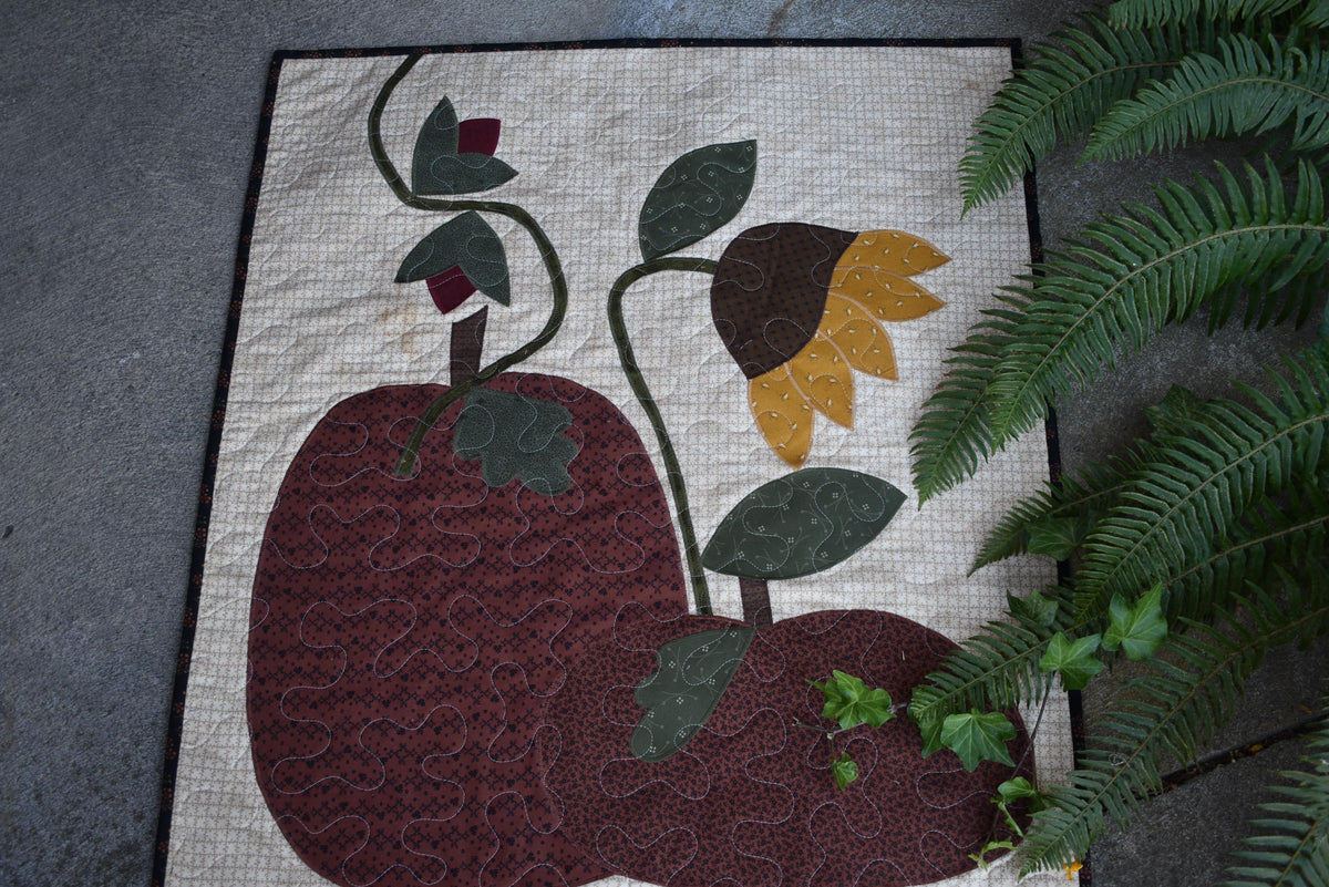 Quilt:  A Quilt measuring 30" high by 26.5" wide    Featuring Two Pumpkins, a Sunflower and other Flowers