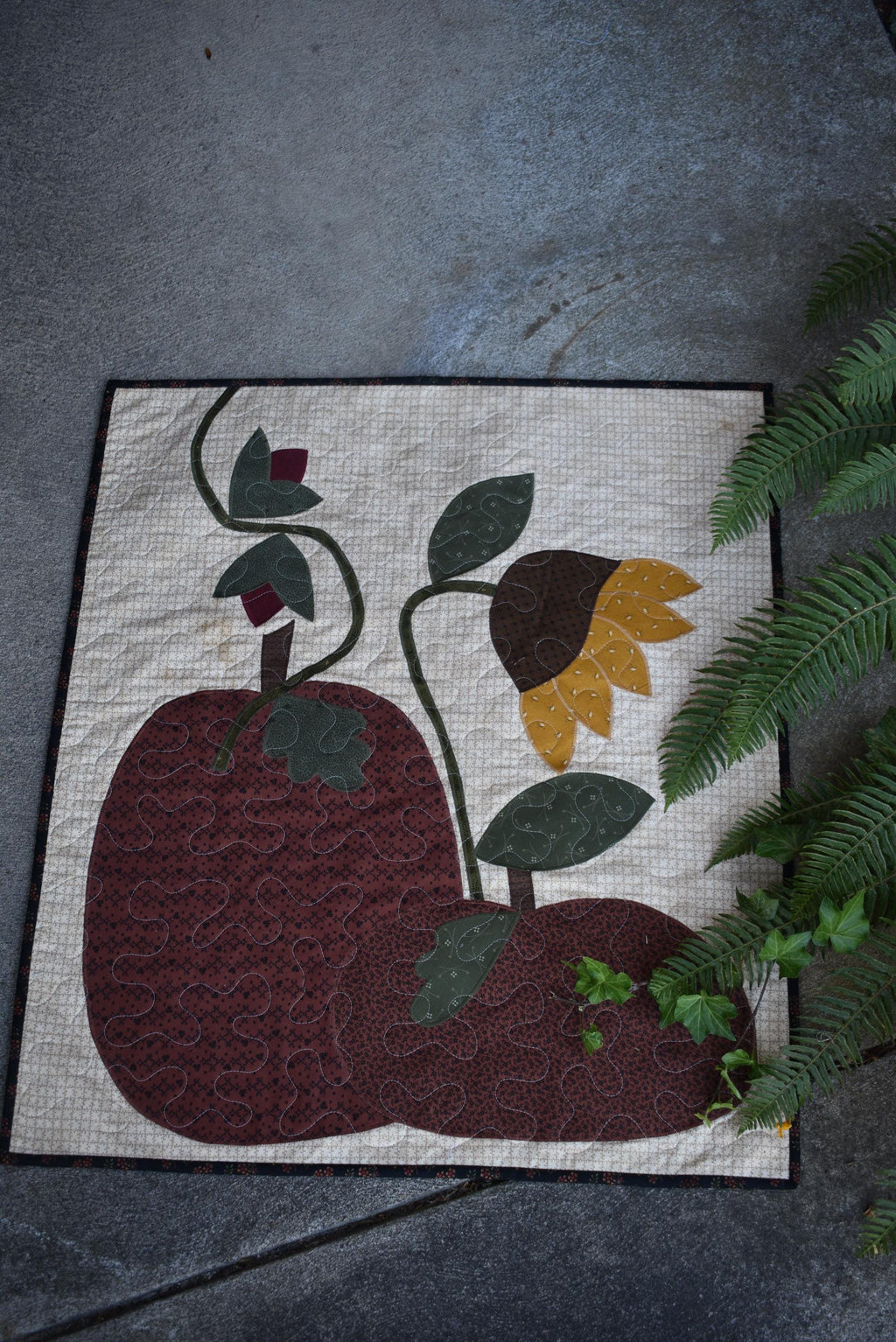 Quilt:  A Quilt measuring 30" high by 26.5" wide    Featuring Two Pumpkins, a Sunflower and other Flowers