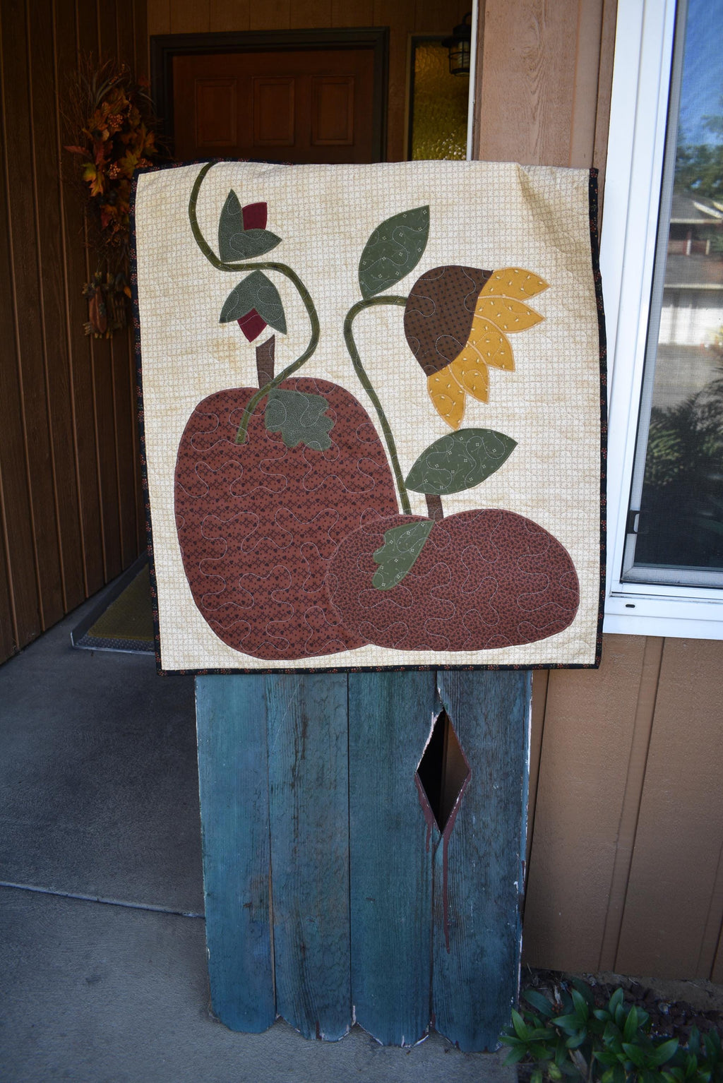 Quilt:  A Quilt measuring 30" high by 26.5" wide    Featuring Two Pumpkins, a Sunflower and other Flowers