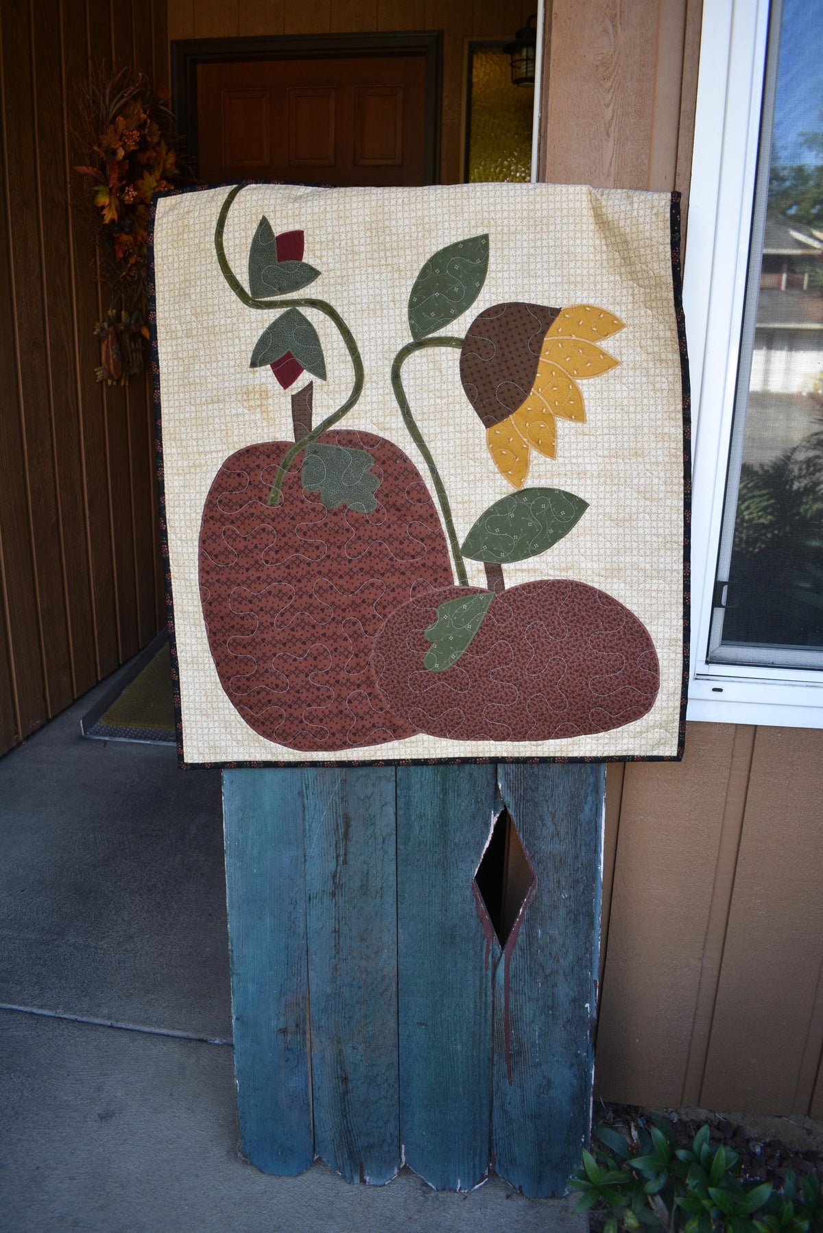 Quilt:  A Quilt measuring 30" high by 26.5" wide    Featuring Two Pumpkins, a Sunflower and other Flowers