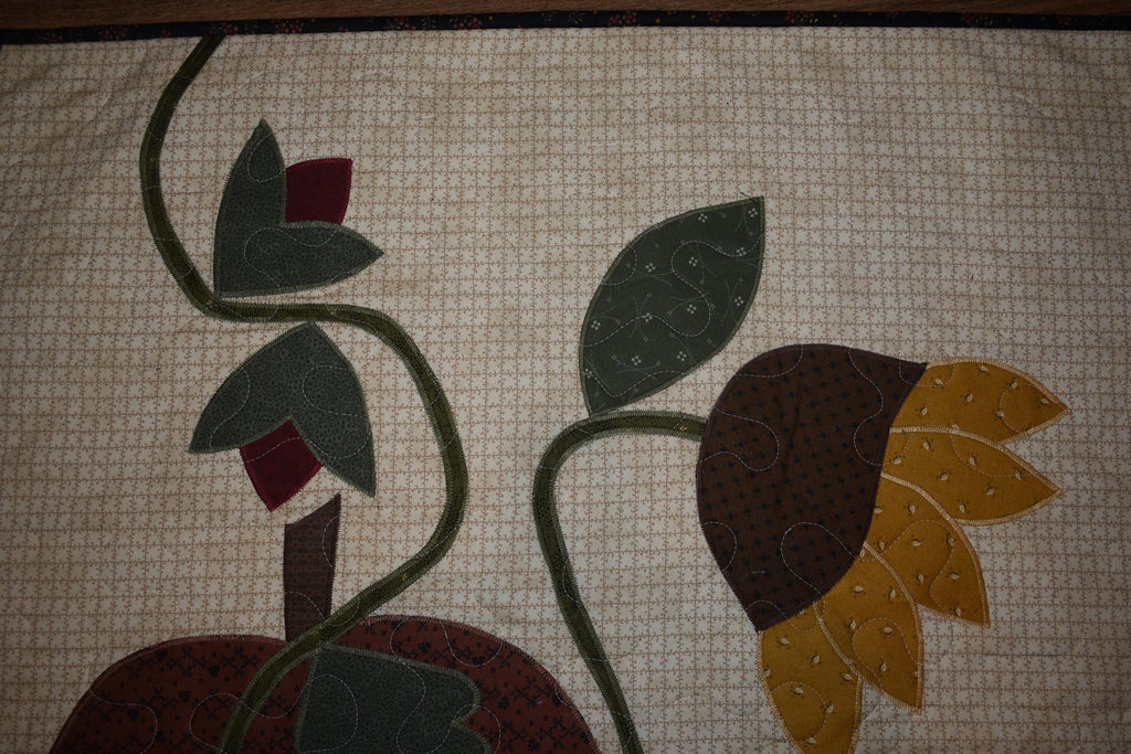 Quilt:  A Quilt measuring 30" high by 26.5" wide    Featuring Two Pumpkins, a Sunflower and other Flowers