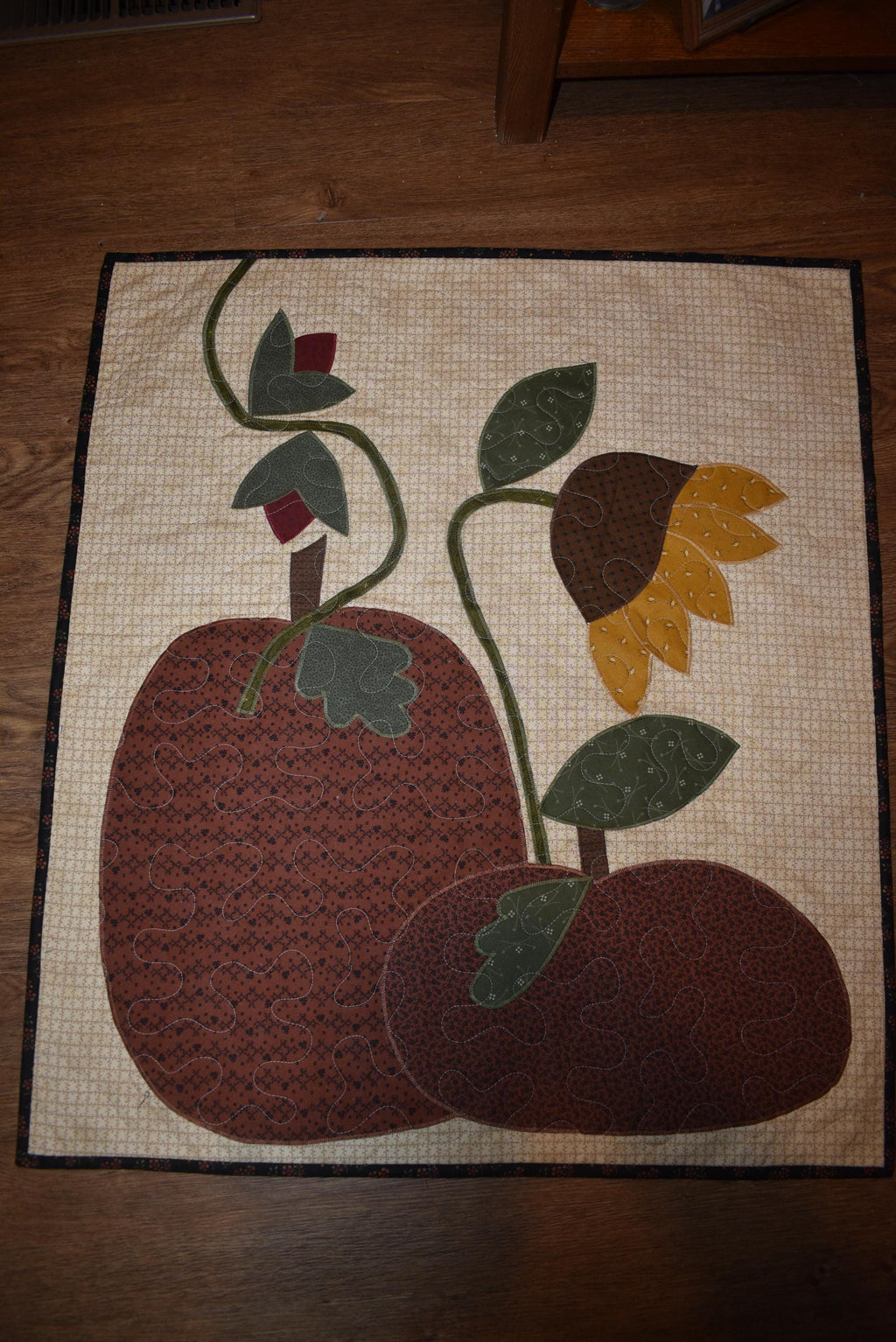 Quilt:  A Quilt measuring 30" high by 26.5" wide    Featuring Two Pumpkins, a Sunflower and other Flowers