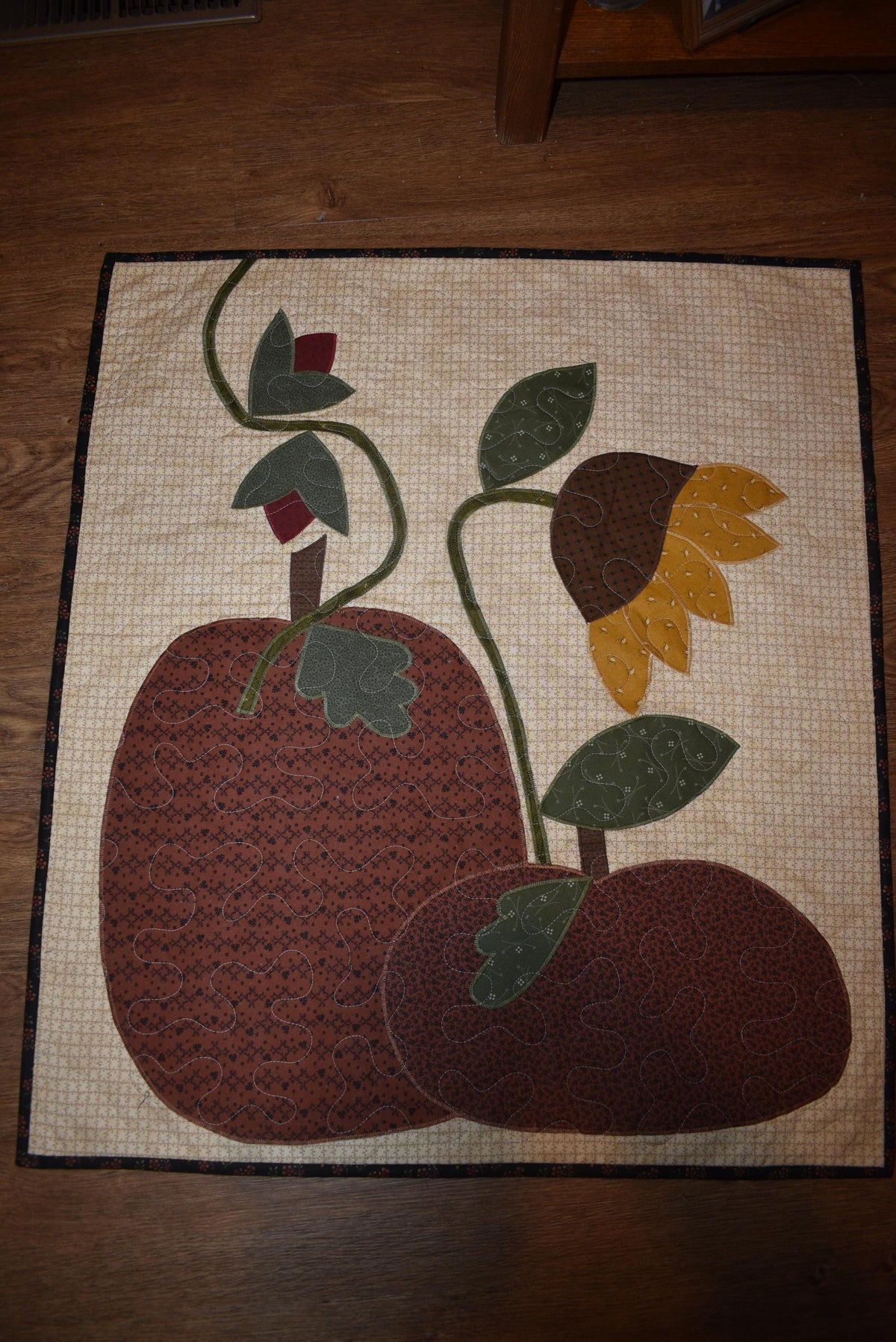 Quilt:  A Quilt measuring 30" high by 26.5" wide    Featuring Two Pumpkins, a Sunflower and other Flowers