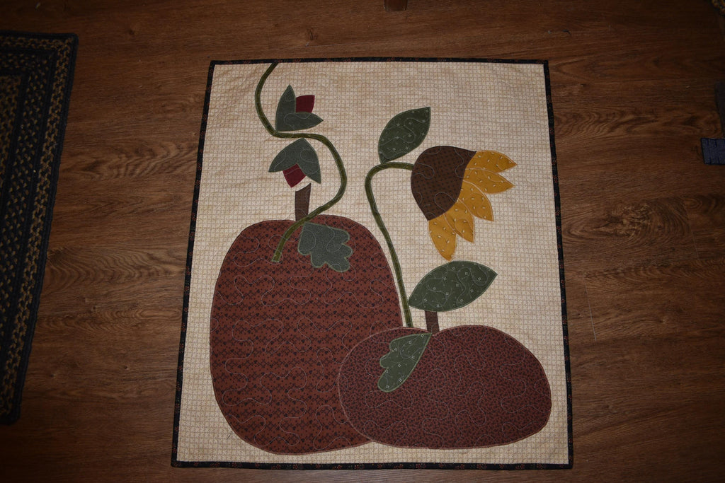 Quilt:  A Quilt measuring 30" high by 26.5" wide    Featuring Two Pumpkins, a Sunflower and other Flowers
