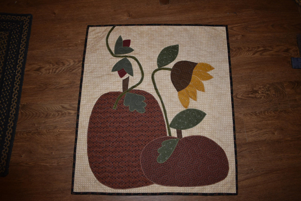 Quilt:  A Quilt measuring 30" high by 26.5" wide    Featuring Two Pumpkins, a Sunflower and other Flowers
