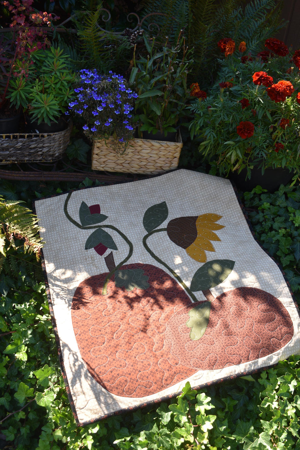 Quilt:  A Quilt measuring 30" high by 26.5" wide    Featuring Two Pumpkins, a Sunflower and other Flowers