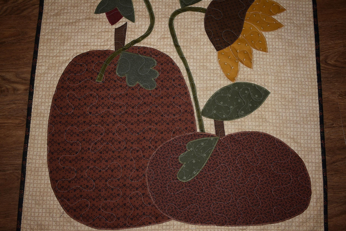 Quilt:  A Quilt measuring 30" high by 26.5" wide    Featuring Two Pumpkins, a Sunflower and other Flowers